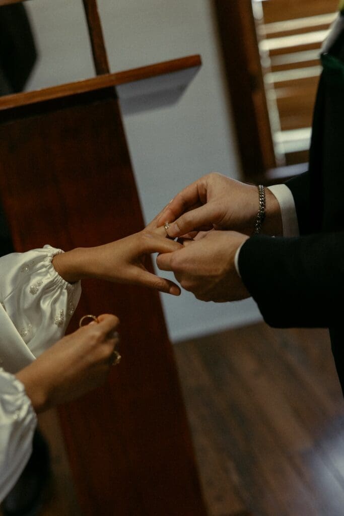 Close-up of a ring exchange during an intimate ceremony at a historic Fredericksburg chapel.