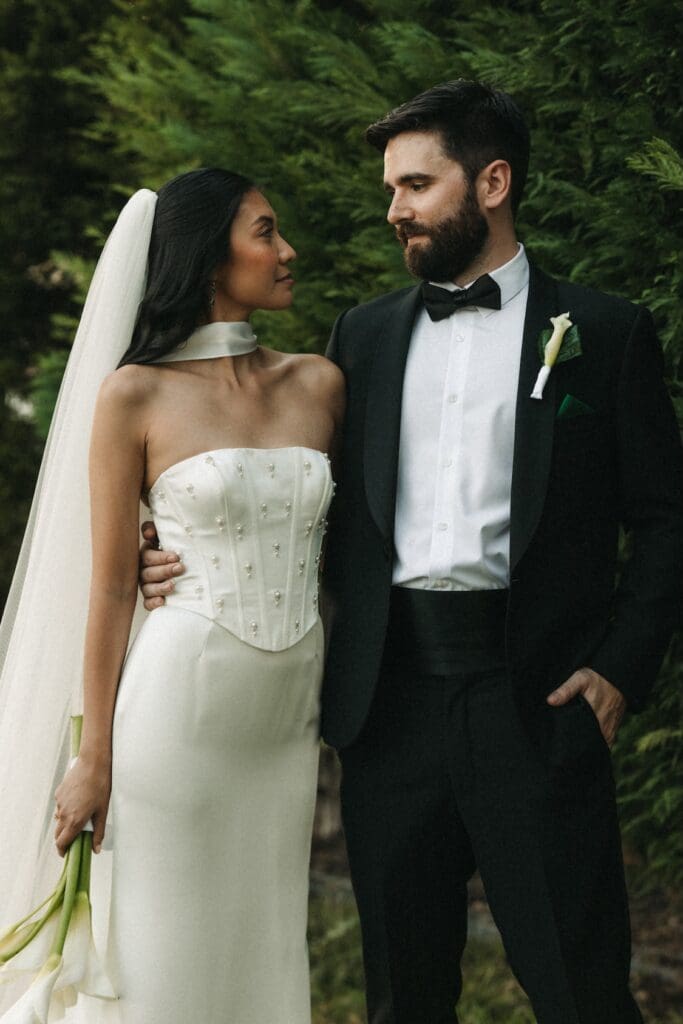 Detail shot of a modern bride's corset bodice and veil, showcasing editorial wedding fashion.